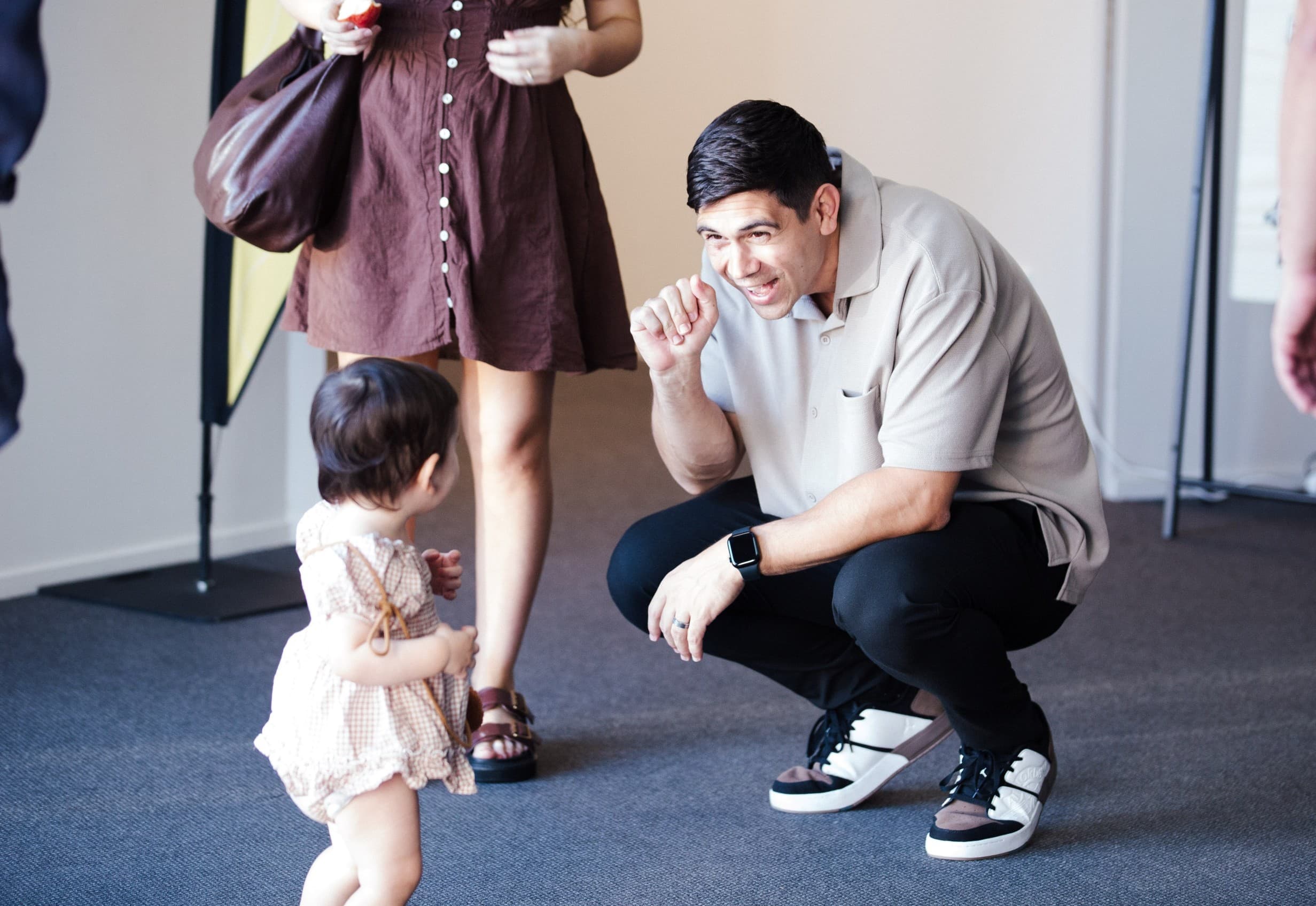 Ps Dan greeting a toddler warmly